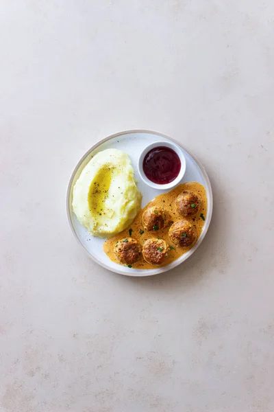 Swedish meatballs in cream sauce, potatoes and lingonberry sauce. Swedish cuisine. Recipe