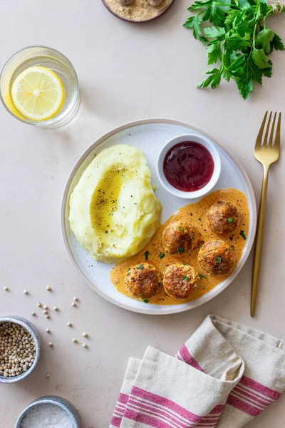 Swedish meatballs in cream sauce, potatoes and lingonberry sauce. Swedish cuisine. Recipe