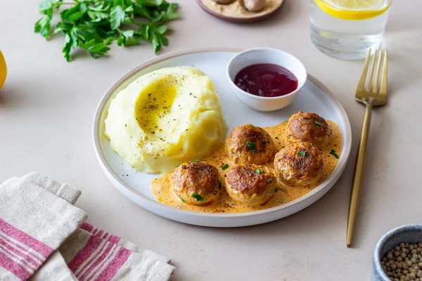 Swedish meatballs in cream sauce, potatoes and lingonberry sauce. Swedish cuisine. Recipe