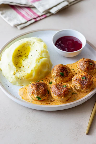 Swedish meatballs in cream sauce, potatoes and lingonberry sauce. Swedish cuisine. Recipe