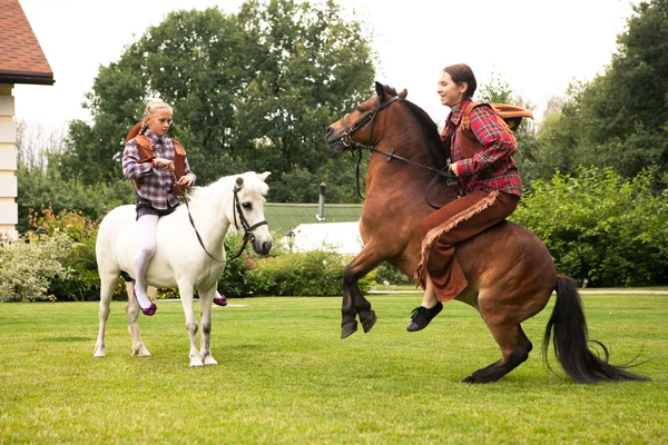 Two girls riding pony — Stock Photo, Image