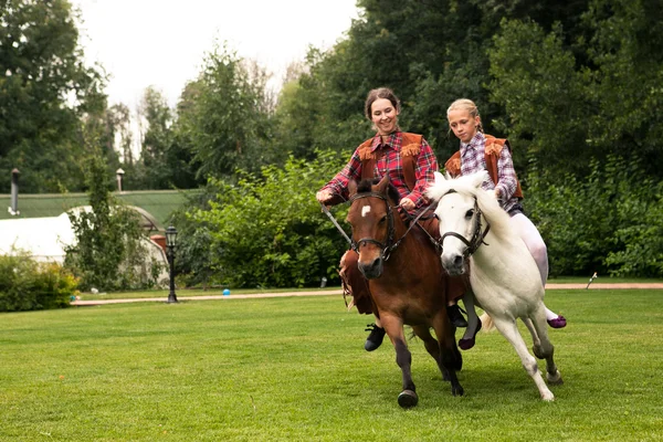 Two girls riding pony — Stock Photo, Image