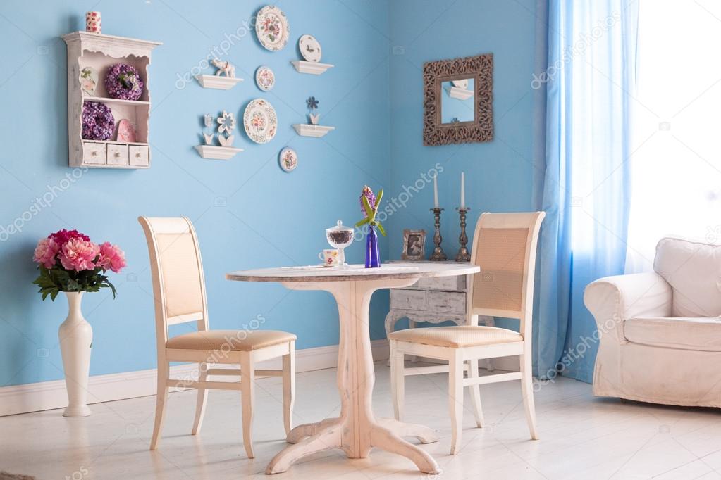 Dining room interior with flowers decorative plates blue wall an