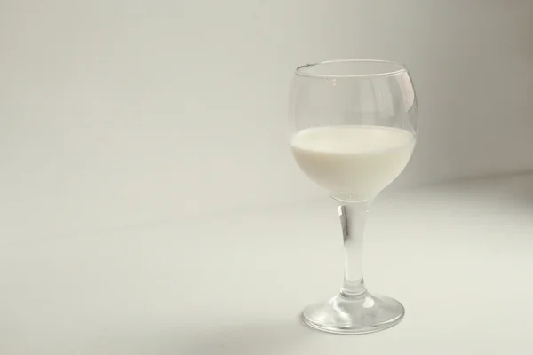 Milk in the wine glass — Stock Photo, Image