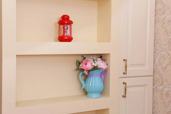 white brand new furniture - sideboard with blue jar and red lamp close up photo