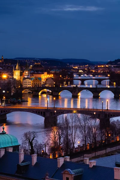 Prague at night, view of bridges on the Vlatava river, reflection of night city lights, cityscape