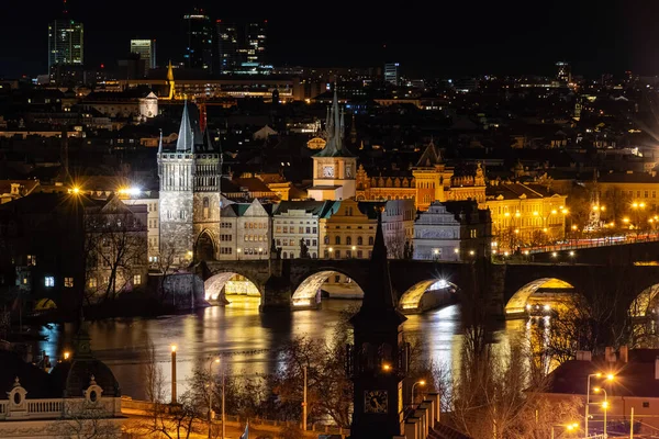 Prague at night, Charles bridge, reflection of lights in the Vltava river, cityscape