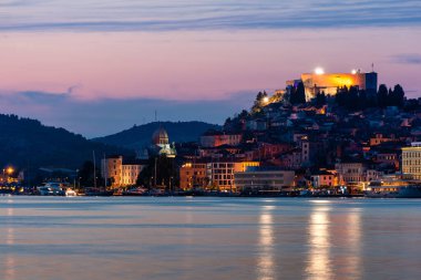 Evening Sibenik city in Croatia, night city lights reflection, cityscape