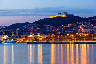 Evening Sibenik city in Croatia, night city lights reflection, cityscape