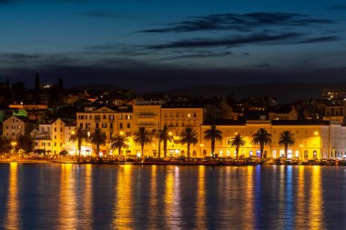 Evening city of Split in Croatia, reflection of the lights of the night city.