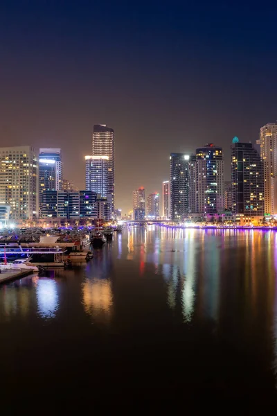 Dubai city at night, reflection of lights on the surface of the water. urban landscape