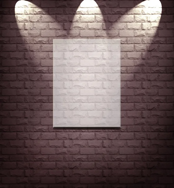 Quadro em branco na parede de pedra iluminado holofotes — Fotografia de Stock