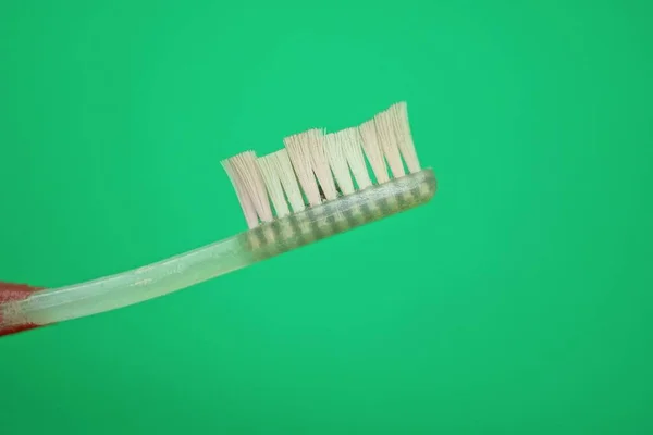 One White Plastic Toothbrush Green Background — Stock Photo, Image