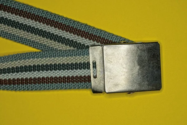Colored Striped Belt Made Fabric Gray Metal Buckle Lies Yellow — Stock Photo, Image
