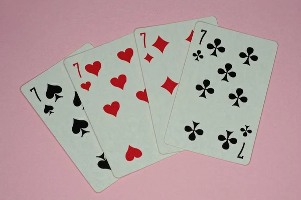 Four Playing Cards Sevens Lie Pink Table — Stock Photo, Image