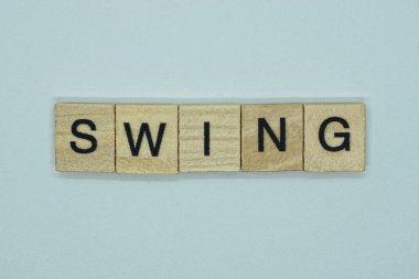 Beyaz arkaplandaki kahverengi ahşap harflerden kelime kelime salınımı