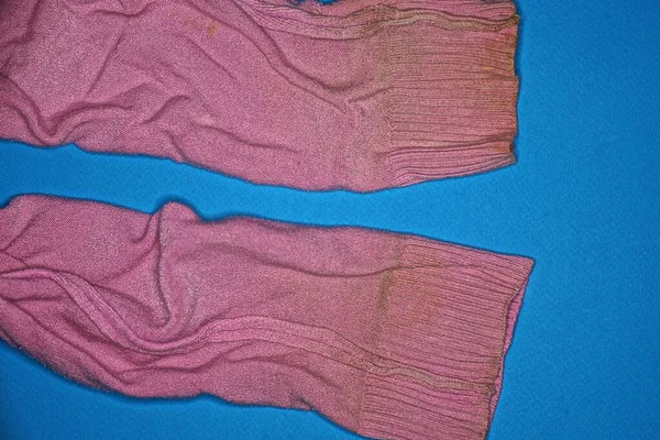 Two Long Dirty Woolen Red Crumpled Sleeves Sweater Lie Blue — Fotografia de Stock