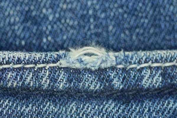 Ein Stück Blaue Jeanshose Mit Weißen Fäden Auf Zerrissenen Stoffjeans — Stockfoto