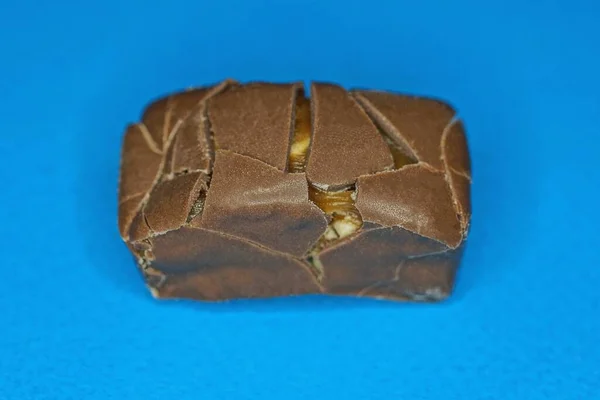 Food One Brown Chocolate Candy Cracks Lies Blue Table —  Fotos de Stock