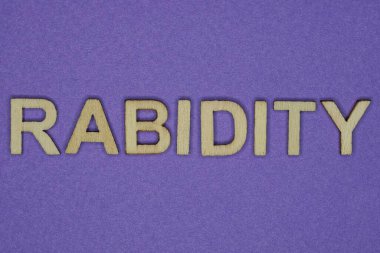 word rabidity in small wooden letters with lilac background