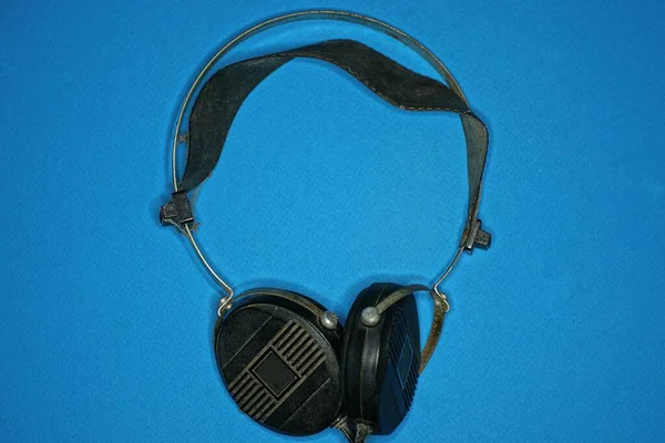 One Old Big Black Audio Headphones Lies Blue — Photo