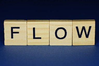 mavi arka planda küçük ahşap harflerle gri kelime akışı