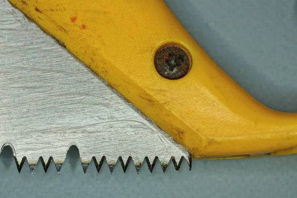 Part Iron Saw Sharp Teeth Yellow Plastic Handle — Stock Photo, Image