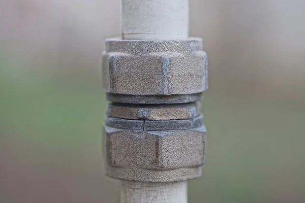 Gray Iron Nuts Screwed White Metal Pipe — Stock Photo, Image