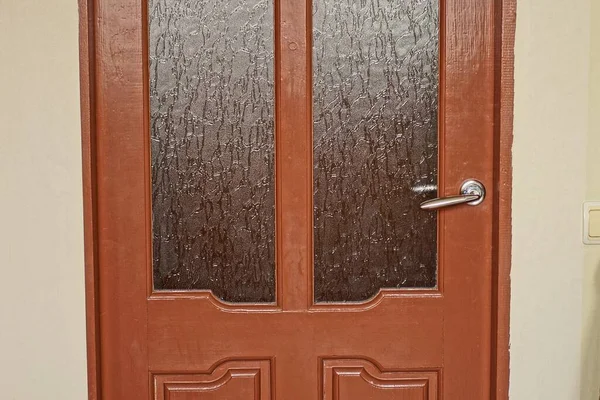 One Closed Brown Wooden Door Gray Glass Metal Doorknob Wall — Stockfoto