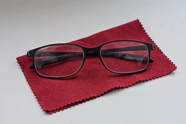 One Black Glasses Lies Red Scarf White Table — Stockfoto