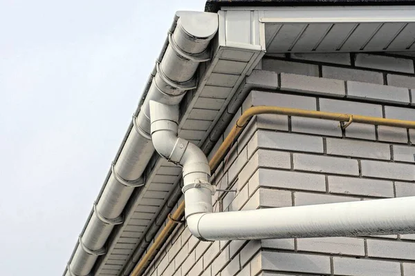 Gray Plastic Gutter Pipe White Brick Wall Outdoors Blue Sky — Stok fotoğraf