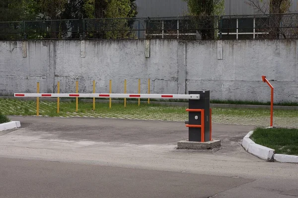 One Closed White Red Automatic Barrier Street Gray Asphalt Gray — стоковое фото