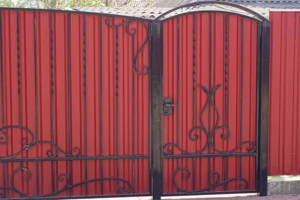 Closed Red Metal Gate Door Black Wrought Iron Pattern Rural — стоковое фото