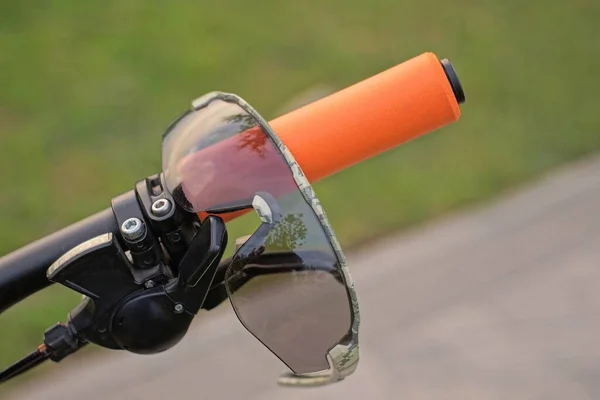 Jeden Szary Plastikowe Okulary Wisi Pomarańczowym Uchwycie Czarny Metalowy Rower — Zdjęcie stockowe