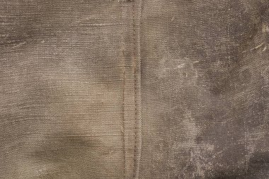 Eski kirli bir muşamba parçası ve dikişten gri siyah kumaş dokusu.
