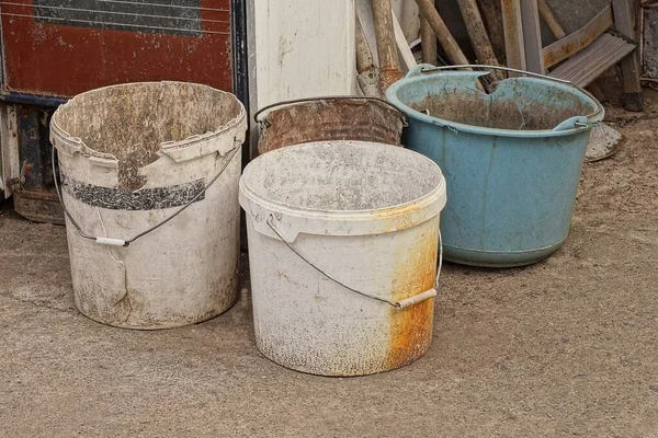 Four Old Dirty Plastic Buckets Stand Street Gray Asphalt — Stock Photo, Image