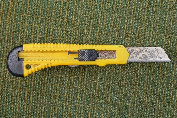 Cuchillo Papelería Negro Amarillo Con Una Hoja Yace Sobre Una — Foto de Stock
