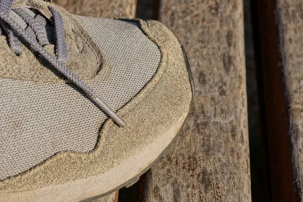 Part One Gray Sneaker Made Fabric Suede Stands Brown Wooden — Fotografia de Stock