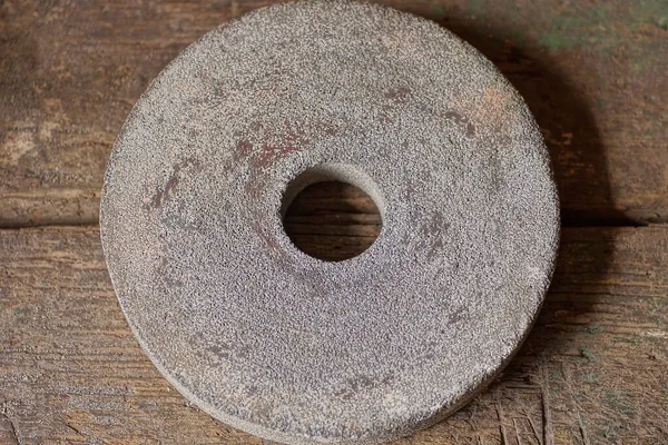 One Old Stone Gray Grinding Wheel Lies Brown Wooden Table — Fotografia de Stock