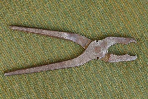 One Old Tool Gray Pliers Rust Lies Green Cloth Table — Foto de Stock