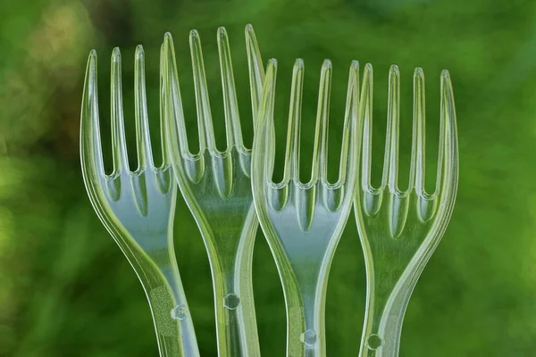 Row Four Transparent White Plastic Forks Green Background — Φωτογραφία Αρχείου