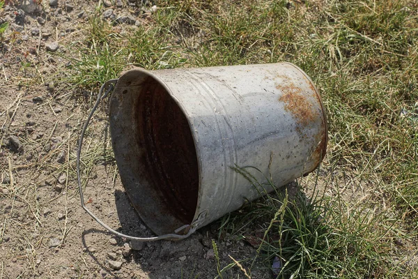 One Old Rusty Empty Metal Bucket Lies Ground Green Grass — Zdjęcie stockowe