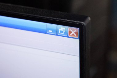 corner of a monitor with a screen with a white browser and a red cross on a blue stripe