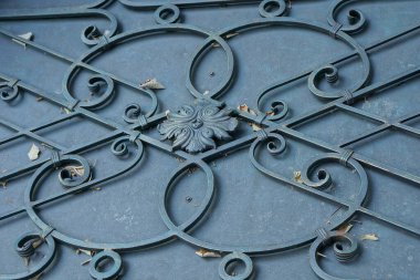 metal texture of black gray forged pattern of iron rods in the wall of the door on the street 
