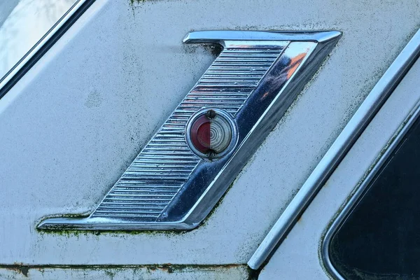 one small round plastic red white old signal headlight on gray metal retro car