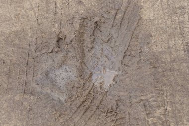 natural texture of brown gray clay and muddy dirty water on the road