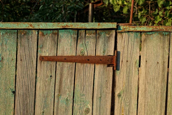 One Old Rusty Metal Brown Door Hinge Gray Wooden Fence — Zdjęcie stockowe