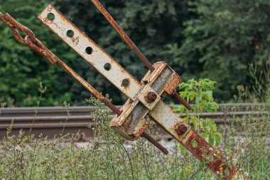 part of an old rusty gray brown iron construction of a nut and bolt on the beam plates in the street