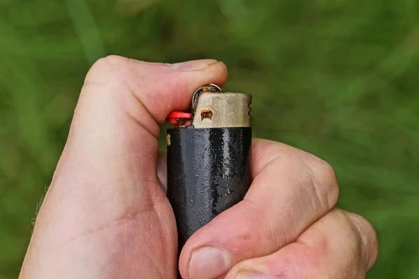 One Black Red Lighter Hand Green Background — 图库照片