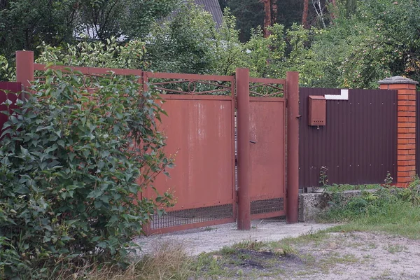 Brown Metal Gate Closed Door Fence Wall Rural Street Green — Zdjęcie stockowe